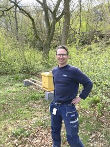 En man framför en bikupa.