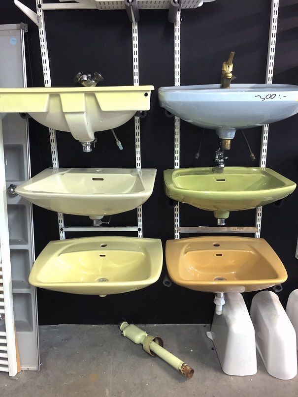 Bilden föreställer sex handfat i olika färger från en av kommunens återvinningscentraler.