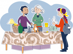 tacknad bild av två personer som säljer begagnade varor från ett bord med brun mönstrad duk.