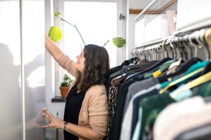 En kvinna sorterar i en garderob.