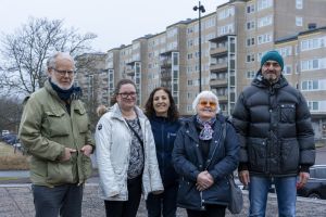 Fem personer i vinterjackor ler in i kameran.