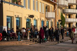 En uteservering med massa folk som fikar.